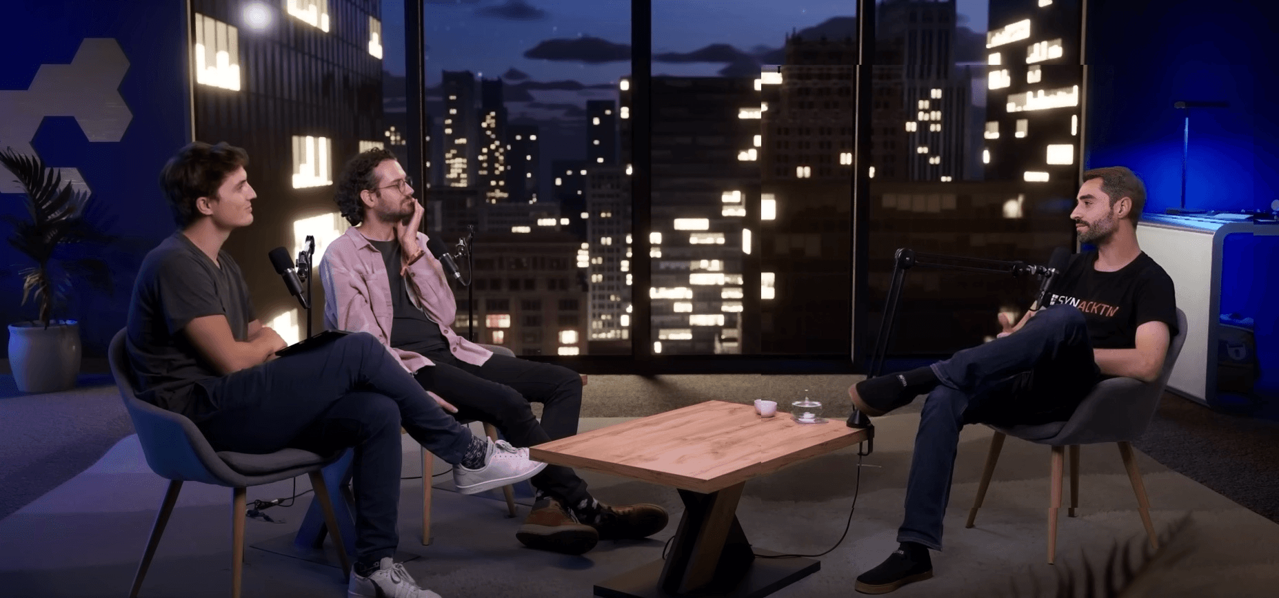 Two men chatting and smiling in a casual workspace