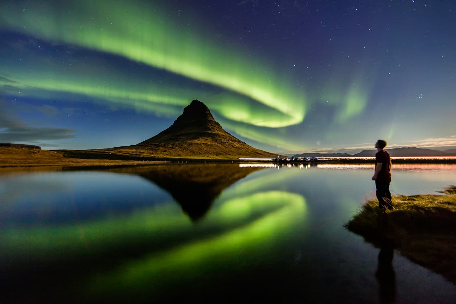 Green aurora borealis over Icelandic landscape