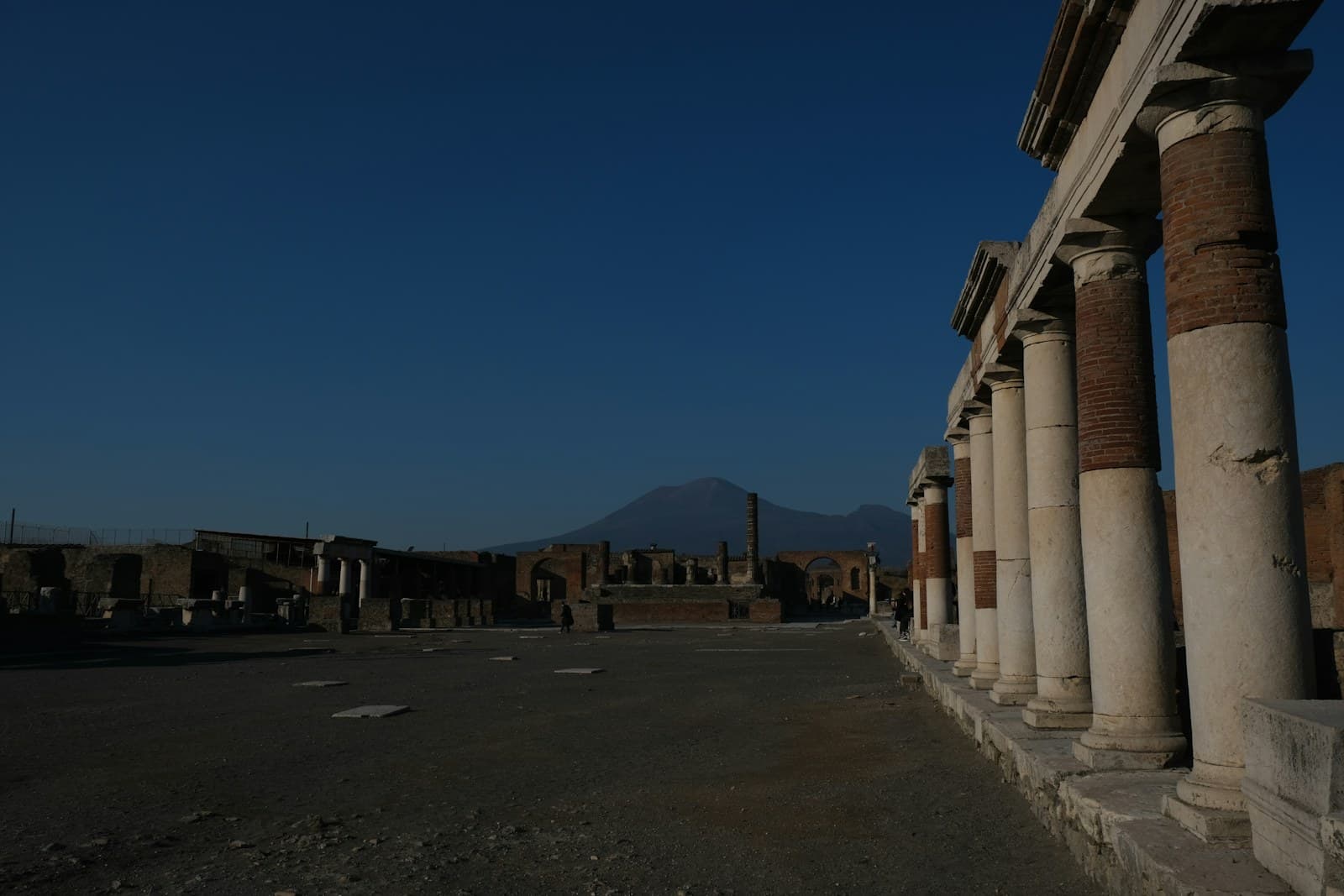 Ancient Pompeii ruins with Mount Vesuvius in the background