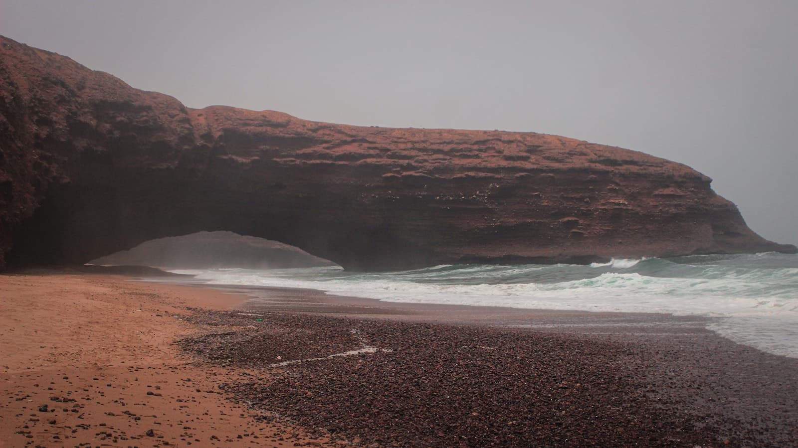 Red sandstone arch over Legzira beach on the Atlantic coast