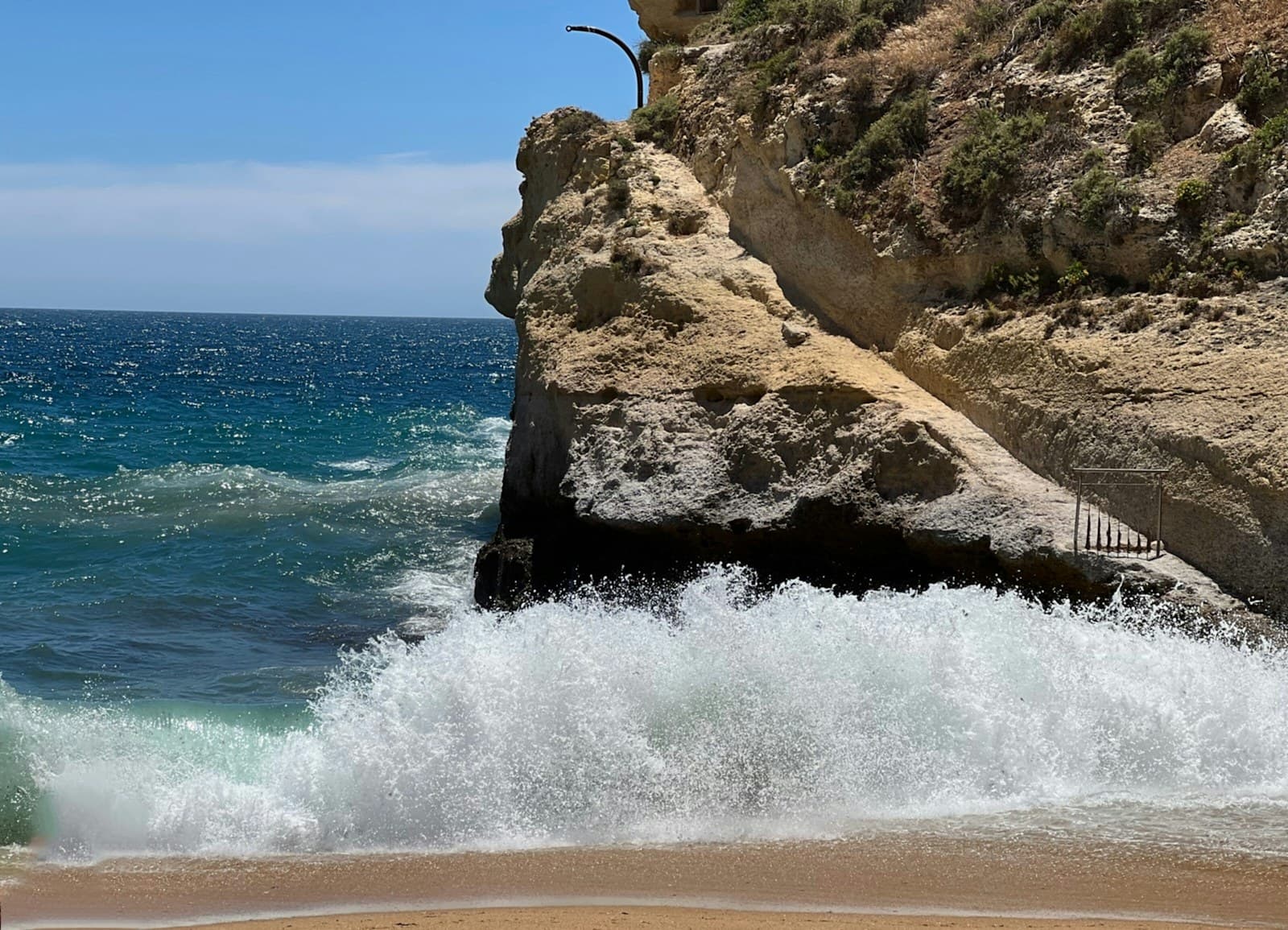 Orange limestone cliffs and turquoise sea on the Algarve coast