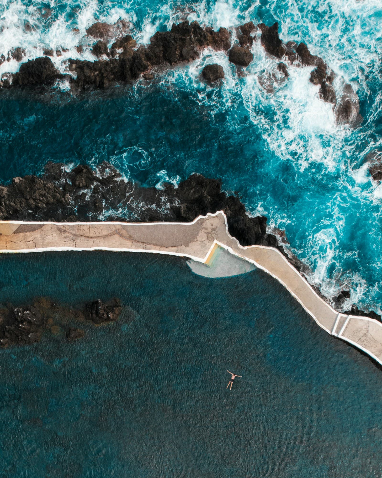 Coastal cliffs and lush green hills of Madeira island