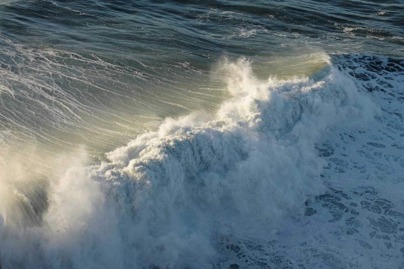 Giant wave breaking at Praia do Norte in Nazaré