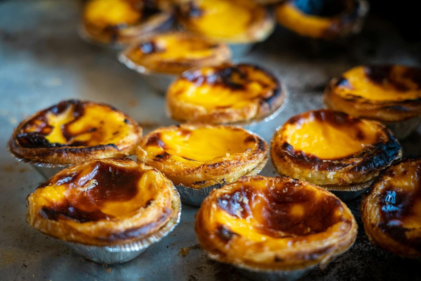 Pastel de nata tarts dusted with cinnamon