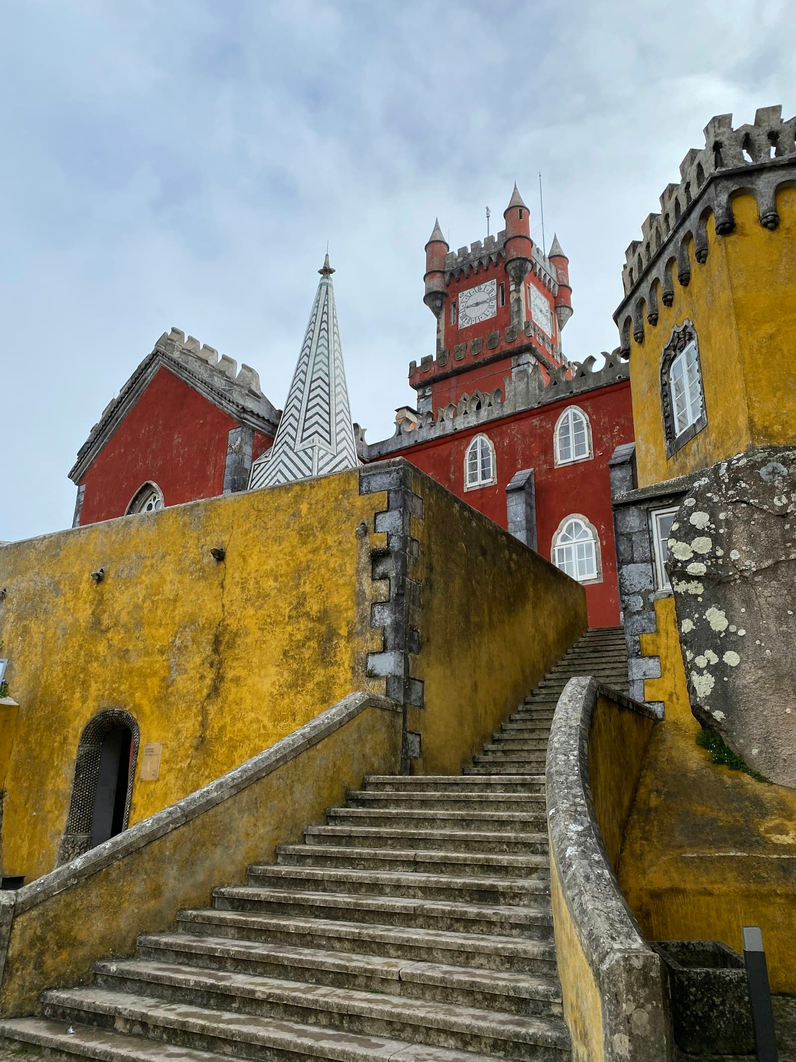 Colorful Pena Palace in Sintra above forested hills