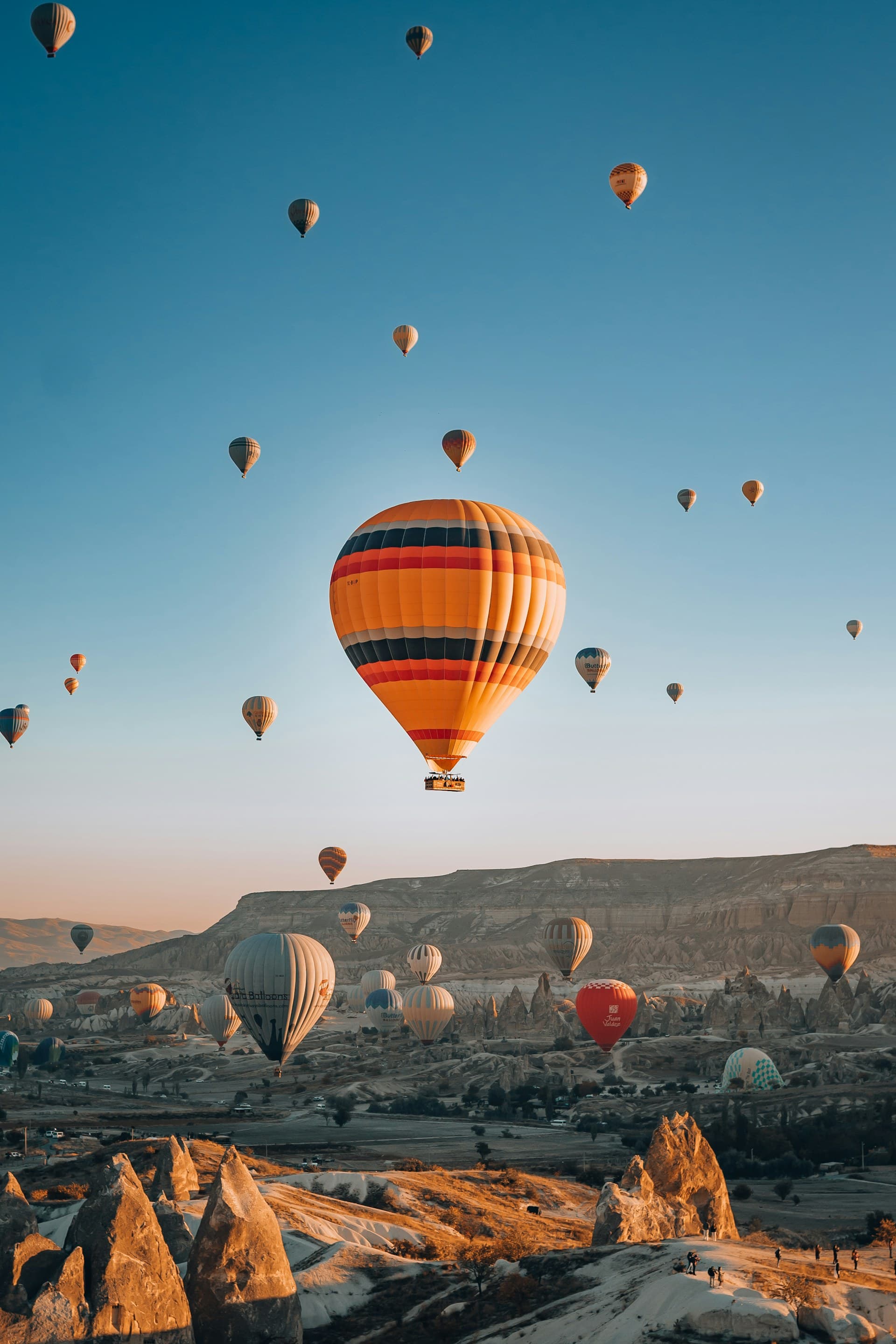 Hot-air balloons over Cappadocia fairy chimneys at sunrise