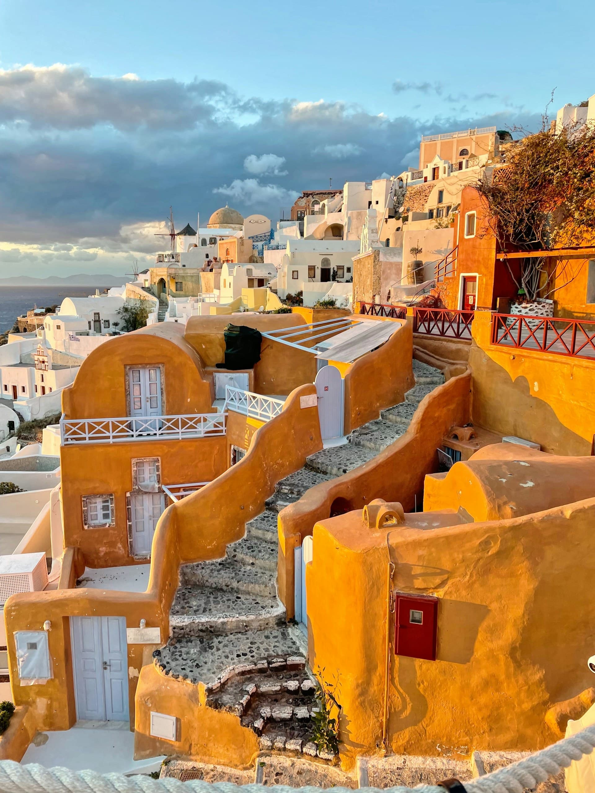 Whitewashed houses and blue domes of Oia, Santorini at sunset