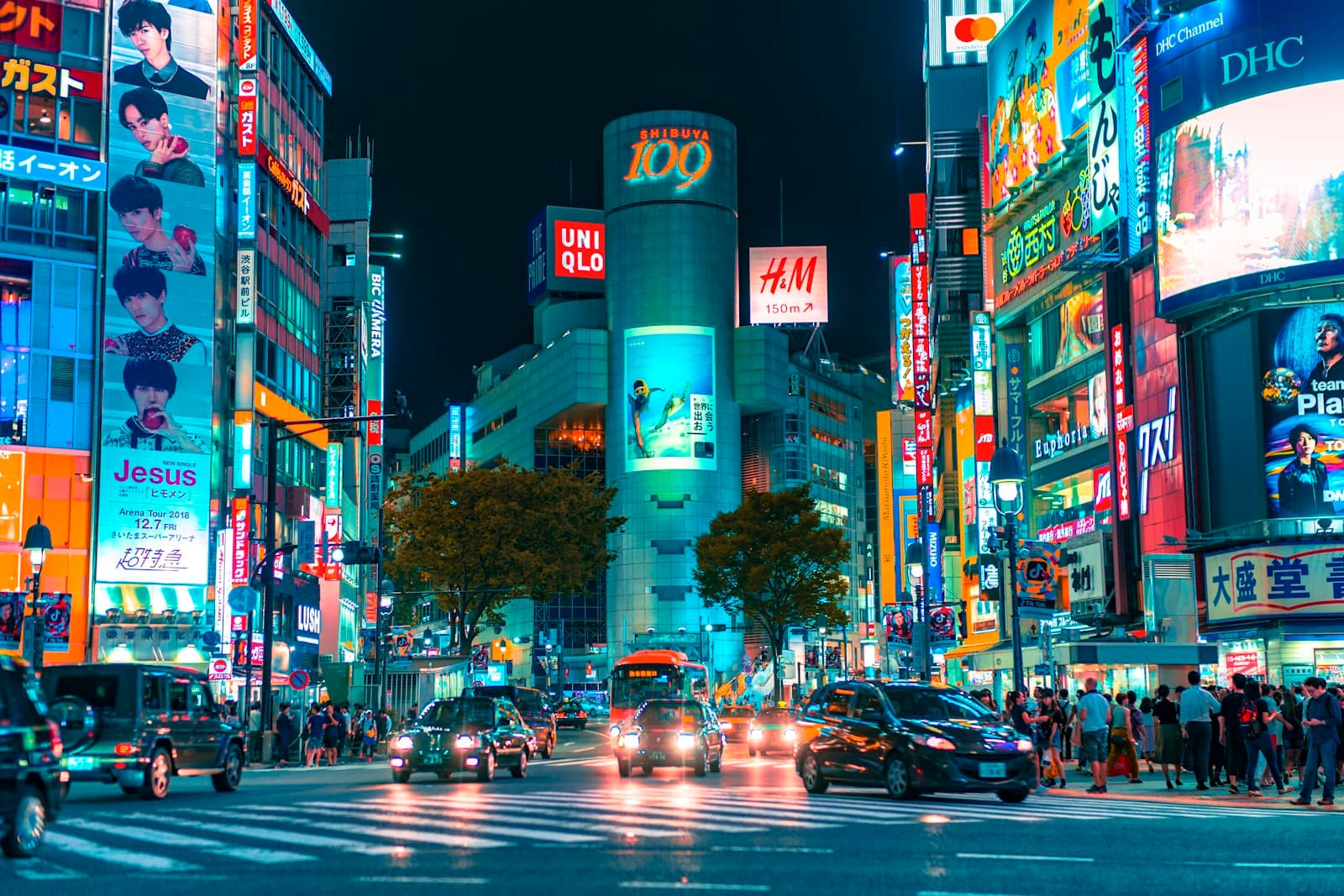 Shibuya scramble crossing at night with neon billboards